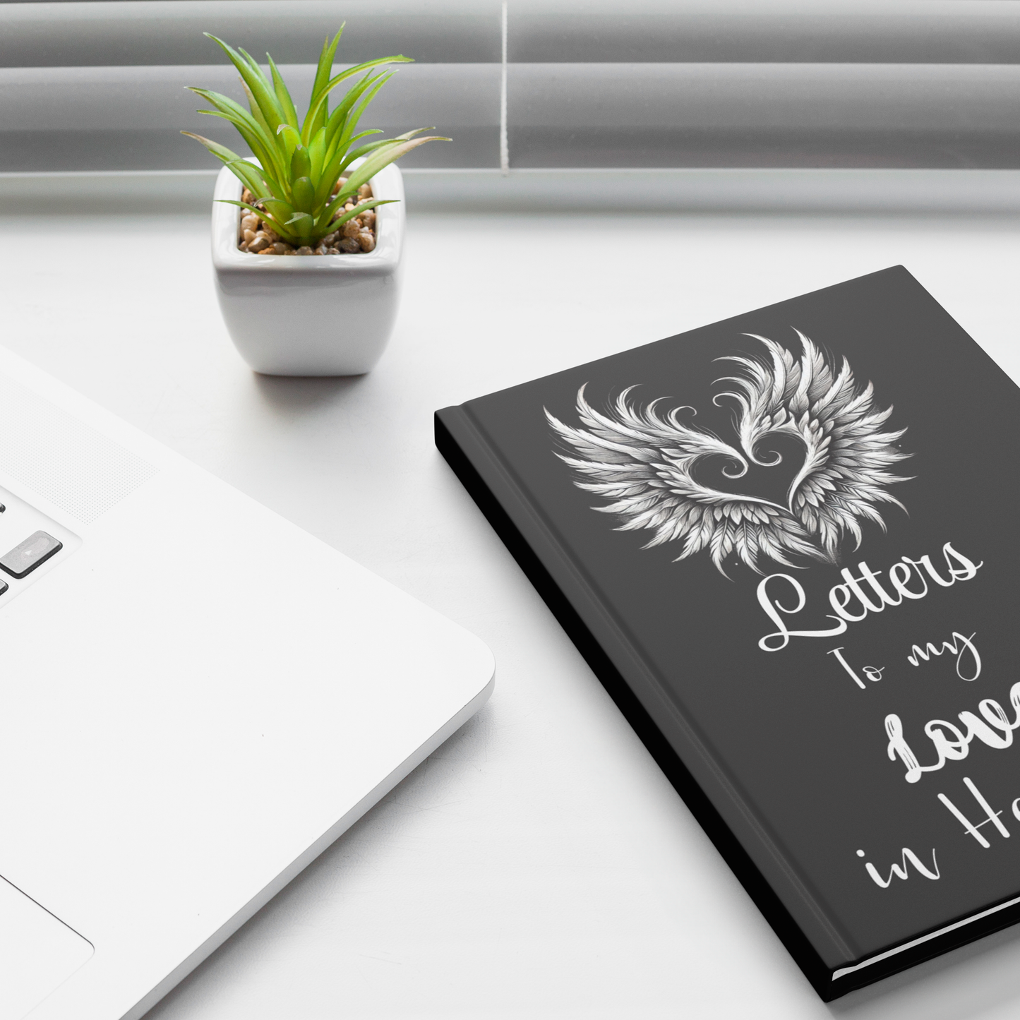 Black hardcover journal with white angel wings heart design and "Letters to my Love in Heaven" text on cover.