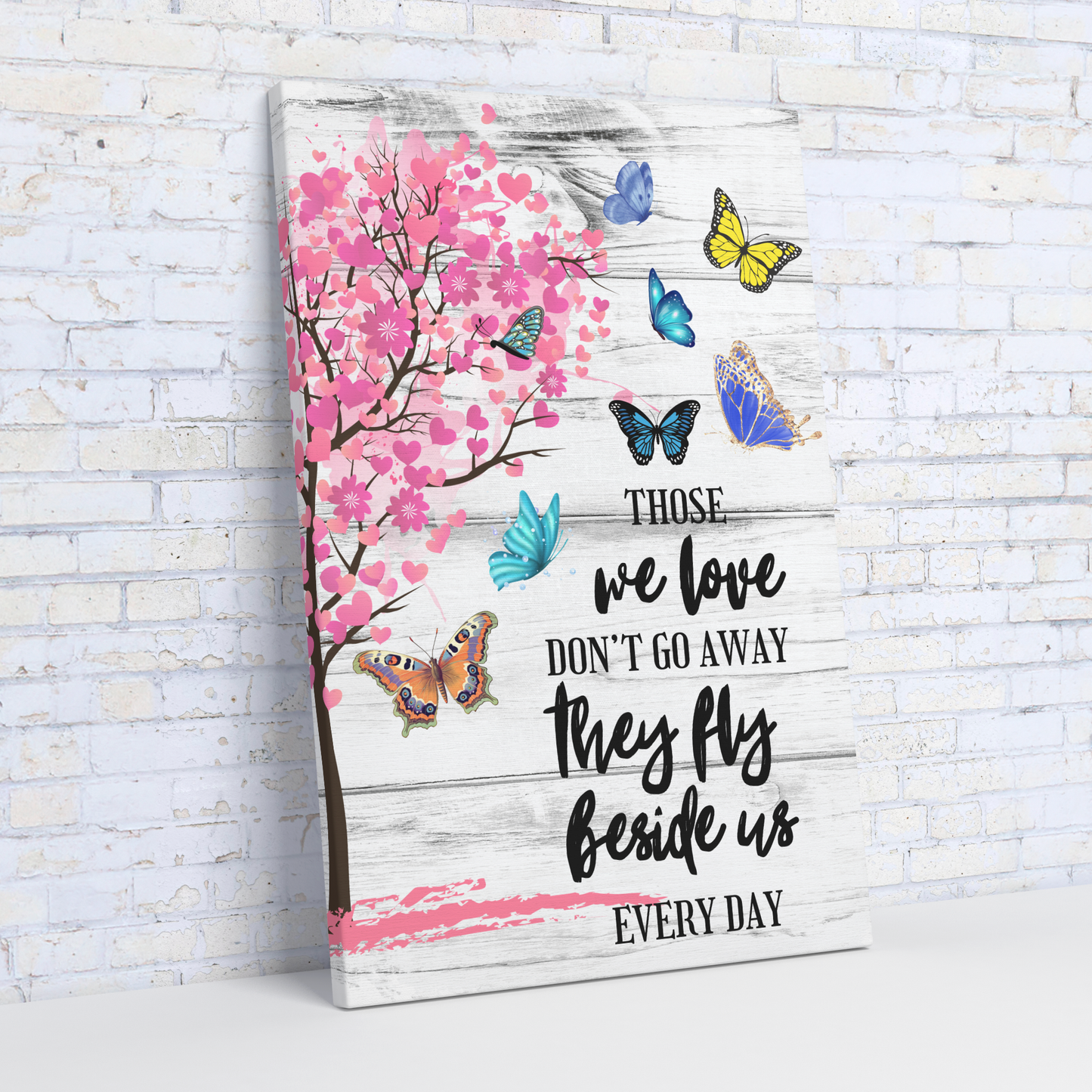 Memorial canvas wall art with pink cherry blossoms, colorful butterflies, and comforting black script text on whitewashed.