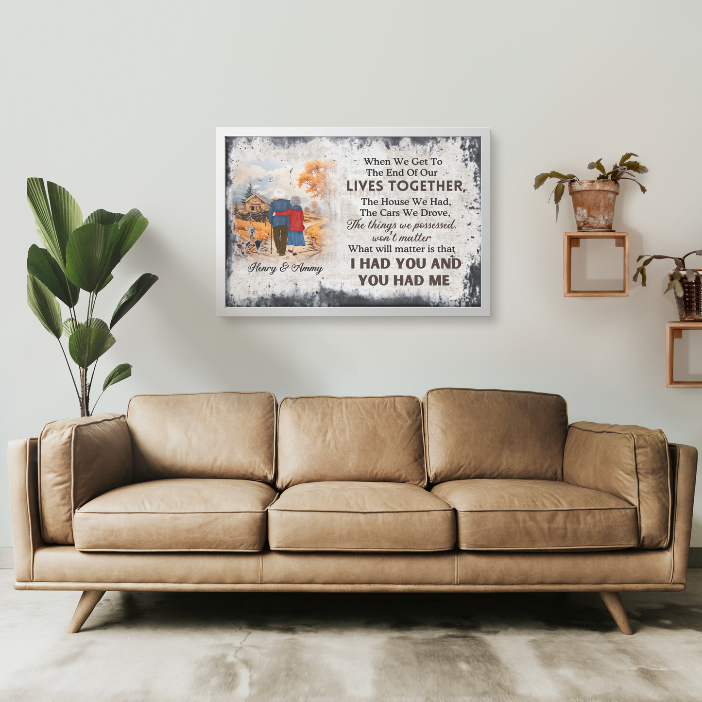 Custom "Together To The End" wall art with illustrated couple on bench and personalized text above beige leather sofa.