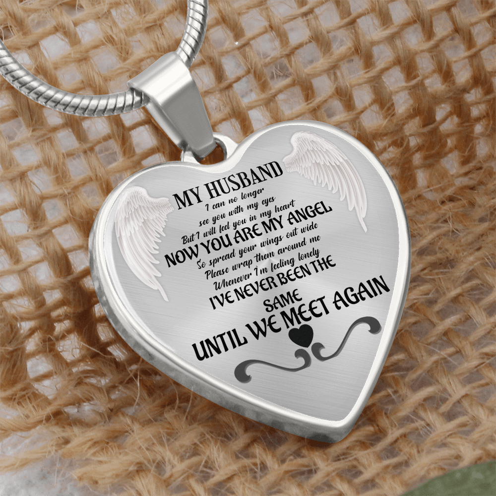 Silver heart-shaped pendant necklace engraved with angel wings and a memorial message for husband.