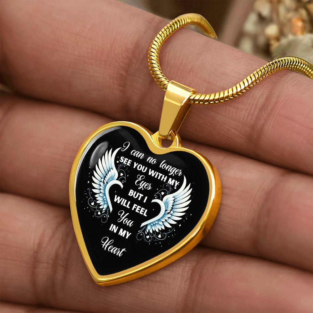 Gold heart-shaped pendant necklace with wing design and "I can no longer see you with my eyes but I will feel you in my heart" inscription.