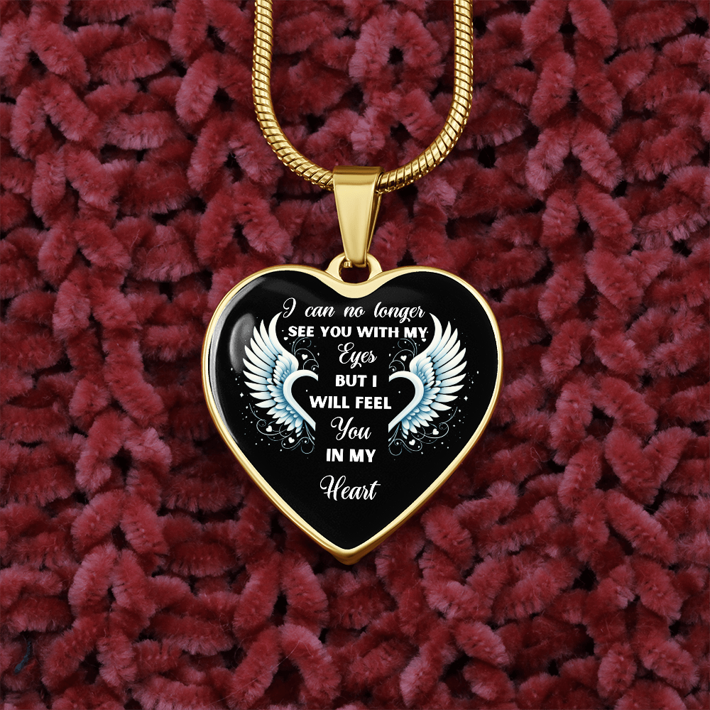 Heart-shaped gold necklace with a remembrance quote on a red fuzzy background.