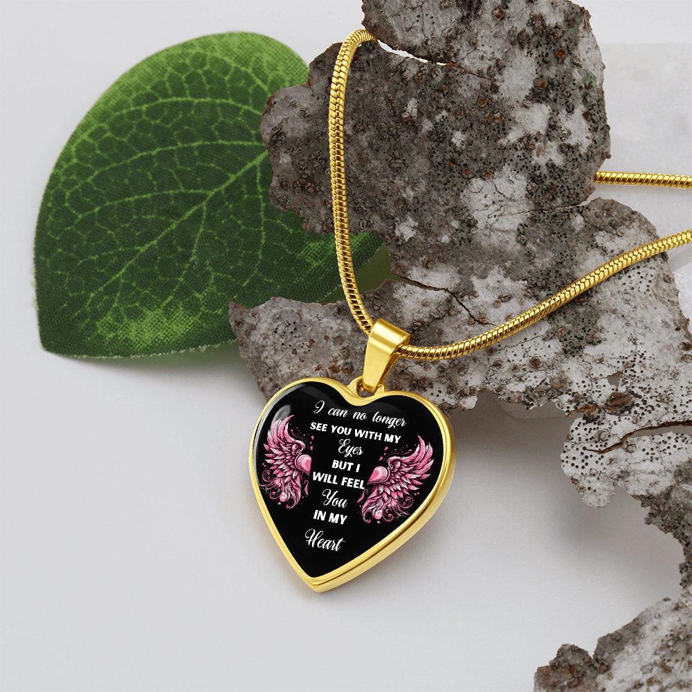 Gold heart-shaped pendant necklace with pink floral accents and engraved sympathy message on black background.
