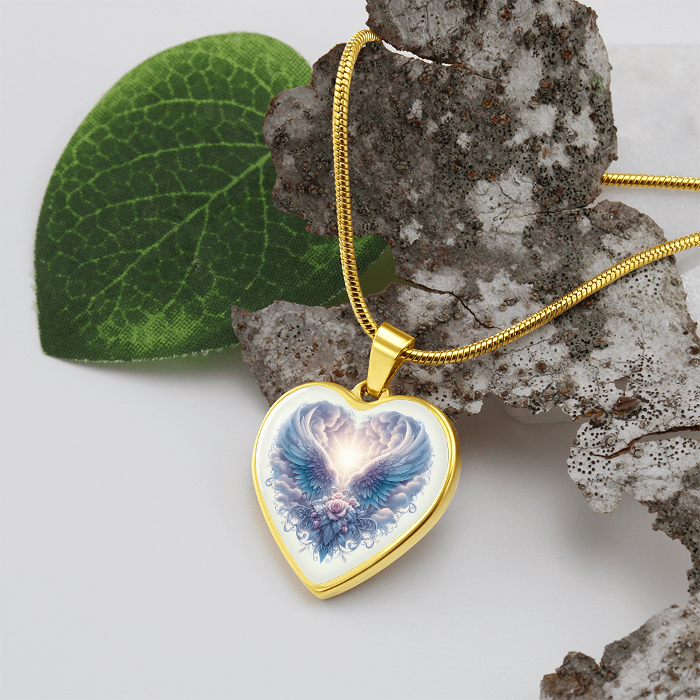 Gold heart-shaped necklace pendant with angel wings graphic on a gold chain.