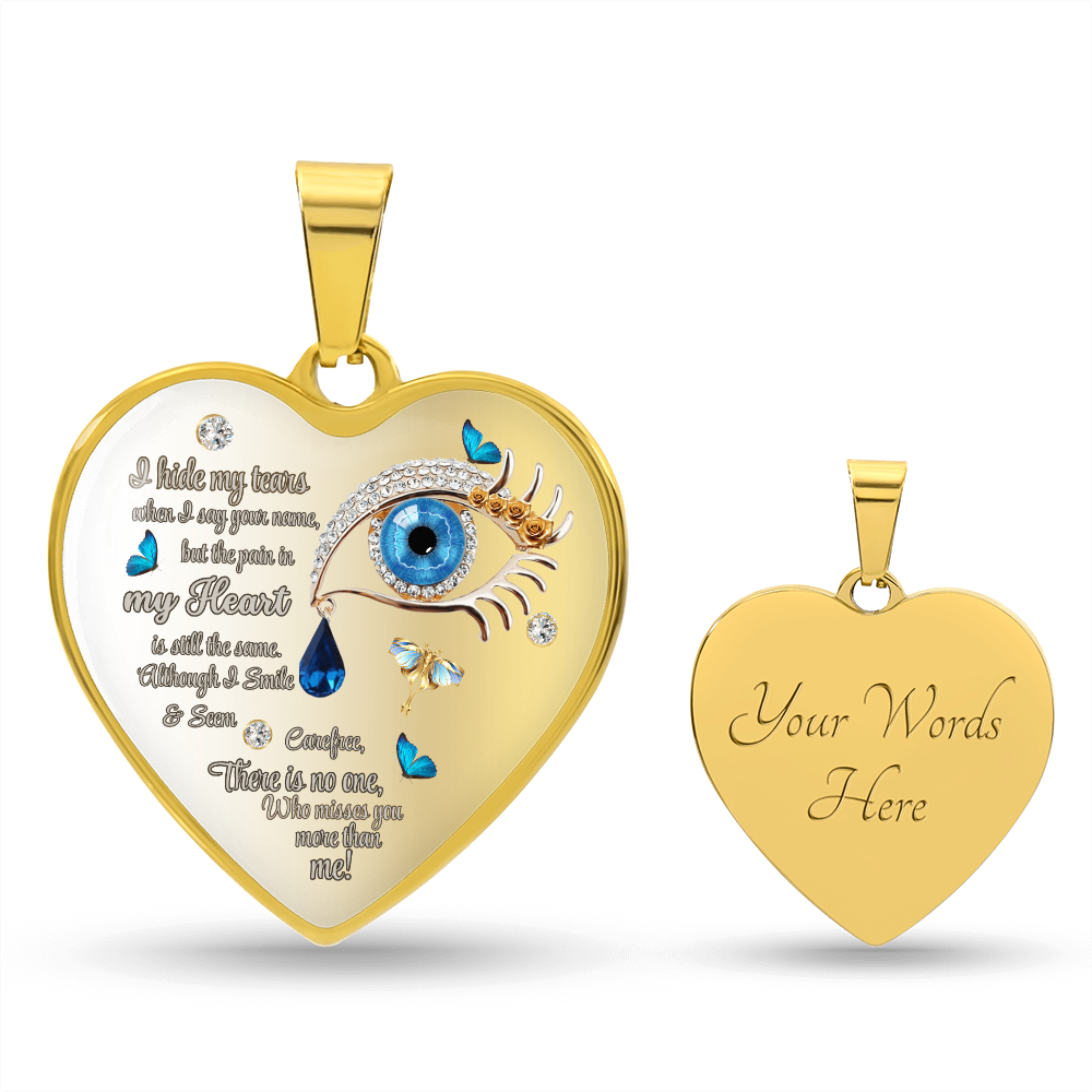 Gold heart-shaped pendant necklace with blue eye graphic, tear drops, and engraved poetic text on front; smooth back with.