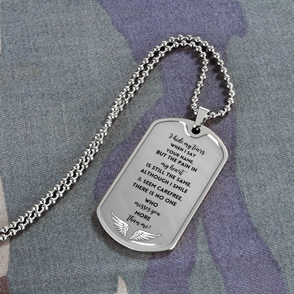 Silver military dog tag necklace with engraved sentimental memorial message and wing design at the bottom.