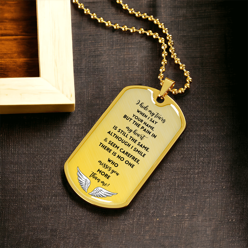 Gold military chain tag necklace with engraved sympathy message and winged emblem at the bottom.