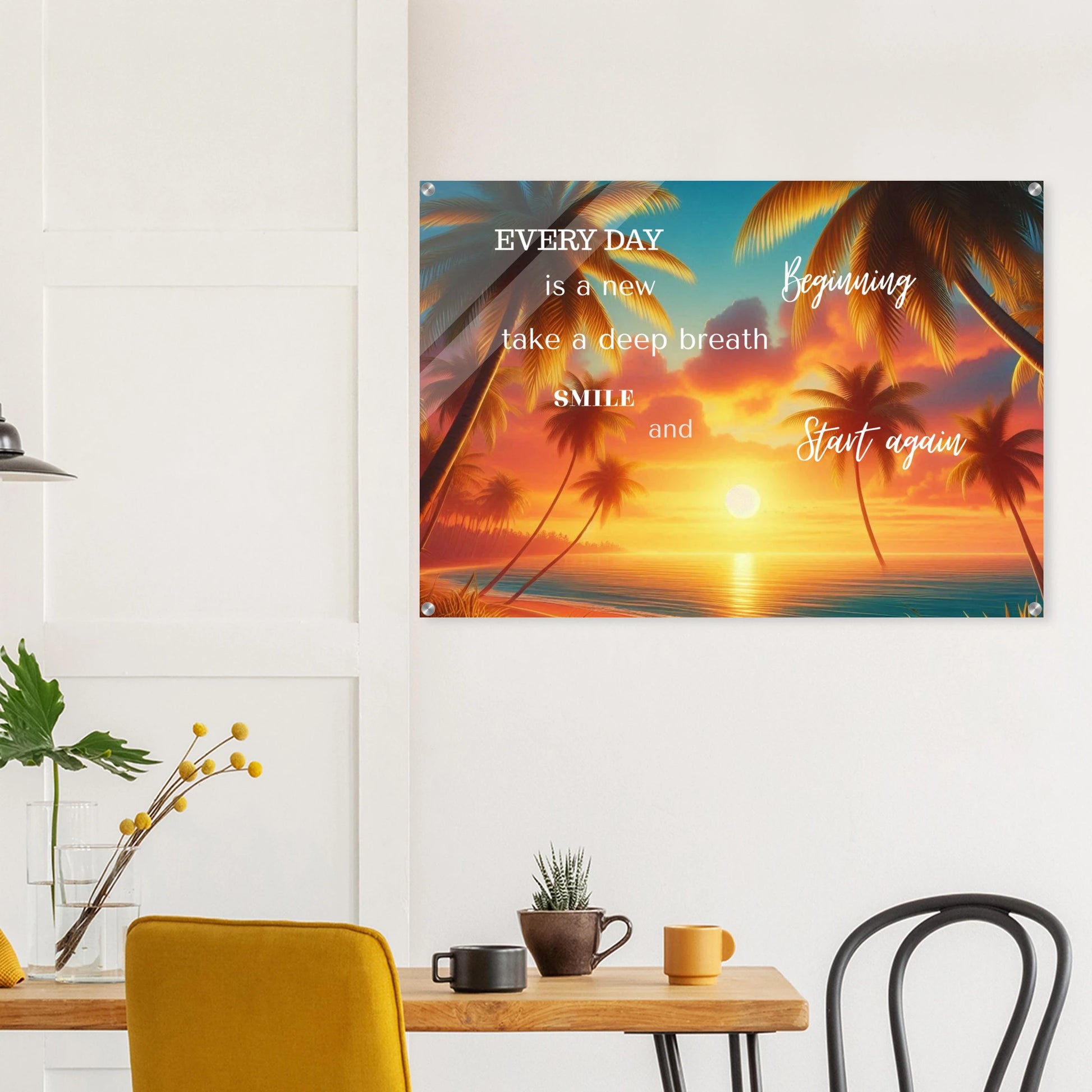 Decorative wall poster with motivational quote and sunset design in a room with a table and chairs.