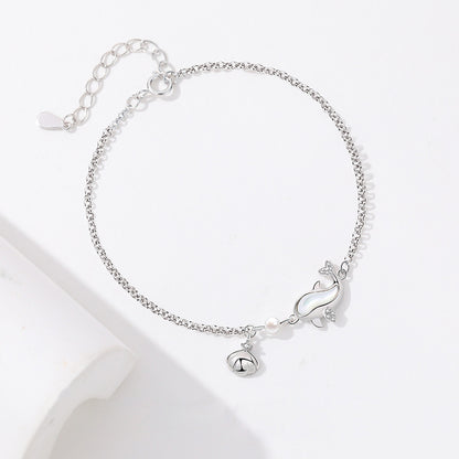 Elegant 925 sterling silver dolphin bracelet with white gold plating, featuring a delicate chain design, adjustable length, and a charming dolphin pendant with a small bell charm, perfect for ocean lovers and fashion-forward individuals.