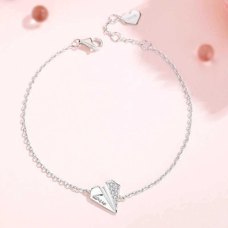 Elegant 925 sterling silver heart bracelet with delicate chain, adjustable length, and sparkling crystal accents on pink background, perfect for romantic occasions or everyday wear