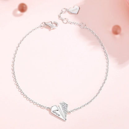 Elegant 925 sterling silver heart bracelet with delicate chain, adjustable length, and sparkling crystal accents on pink background, perfect for romantic occasions or everyday wear